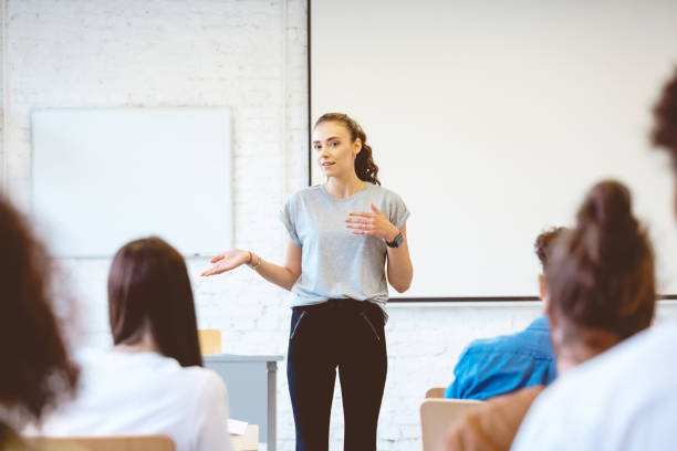 istock Young woman giving presentation in university 1324197490