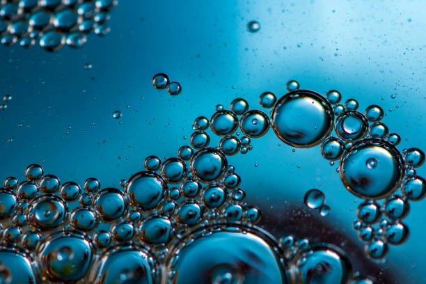 istock Oil bubbles. Macro photo. Blue background. 1324197796