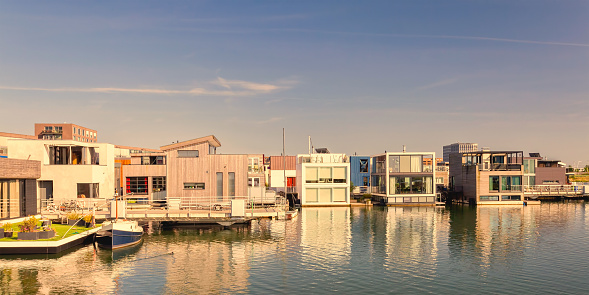Row of contemporary house boats in the IJburg district during sunset in Amsterdam, The Netherlands