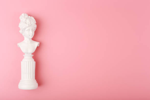 istock White woman gypsum statue on pink background with copy space 1324199512