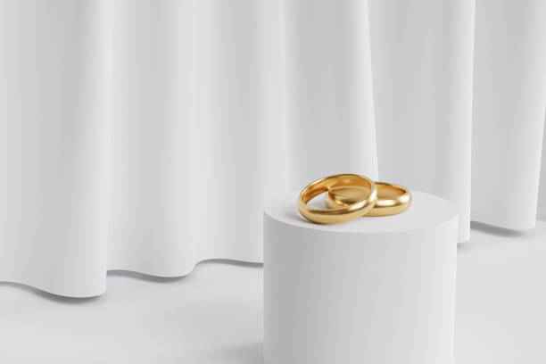 istock Two golden wedding rings on podium or pedestal, background with white curtains, 3d render 1324202479