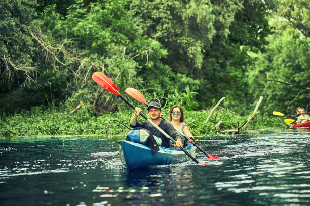 istock Happy best friends having fun on a kayaks. Kayaking on the river. 1324202619