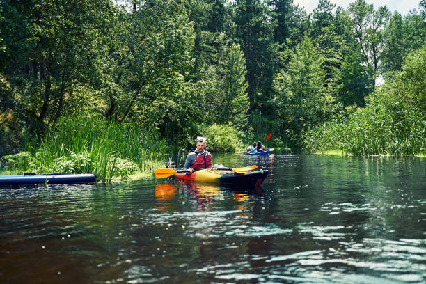 istock Happy best friends having fun on a kayaks. Kayaking on the river. 1324202626