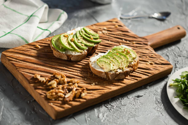 istock Avocado sandwich on dark rye bread made with fresh sliced avocados from above. Breakfast concept. 1324203984