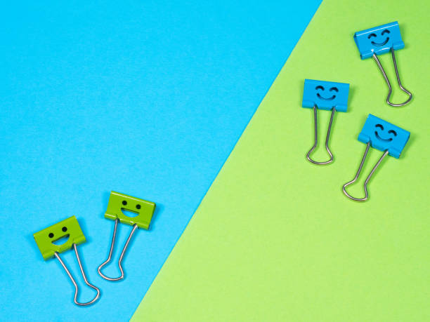 istock Multicolored paperclip on blue green background 1324206238