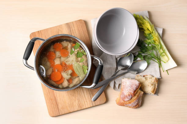 istock Delicious vegetable bouillon served on wooden table, flat lay 1324207111