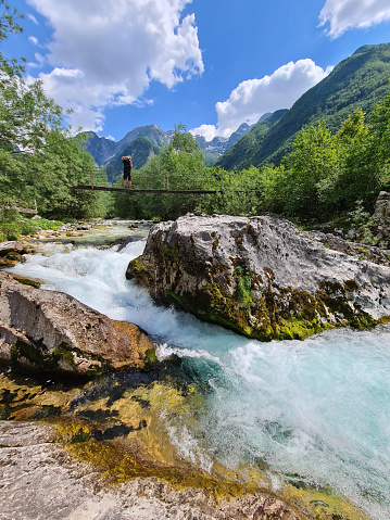 A turbulent river flows between rocks in the mountains