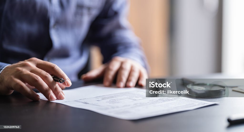 Man Filling In The Tax Form Contract Stock Photo
