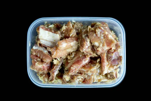 Photo of Raw Fresh pork ribs mix with garlic and pepper in plastic box.
