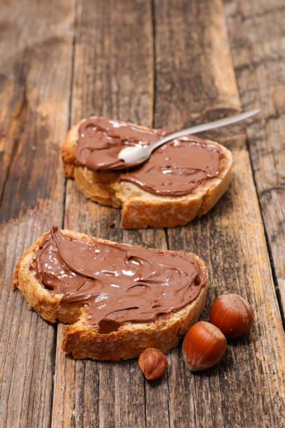 istock spreading chocolate on slice of bread 1324211523