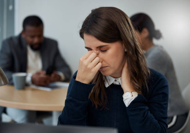 istock Shot of a young businesswoman experiencing a headache while at work 1324213291