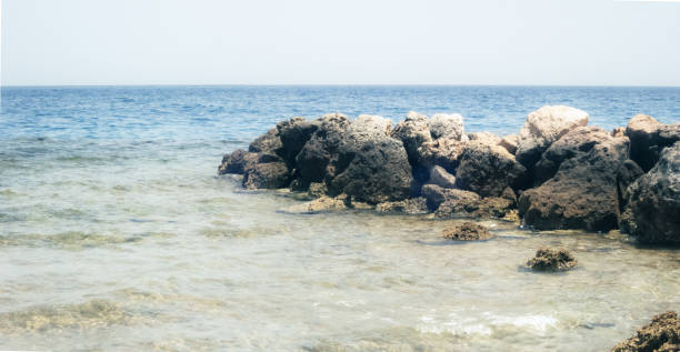 istock Rocks on the sea and empty sky 1324213548