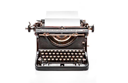 Old mechanical typewriter on a white background