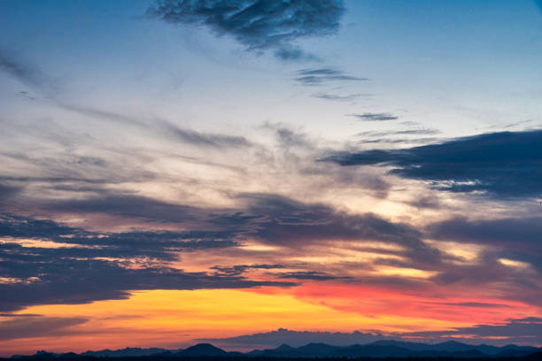 istock Beautiful cloudscape and dramatic sunset over mountain and sea. 1324215440