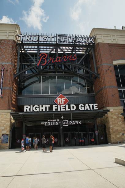 Entrance to Truist stadium in Atlanta, GA Atlanta, GA, USA: June 12,2021-An entrance to Truist Stadium in  Atlanta, Georgia. The stadium is a ballpark and the home field of Major League Baseball team of Atlanta Braves and is located in a multi use complex The Battery with many shops and restaurants. american league baseball stock pictures, royalty-free photos & images