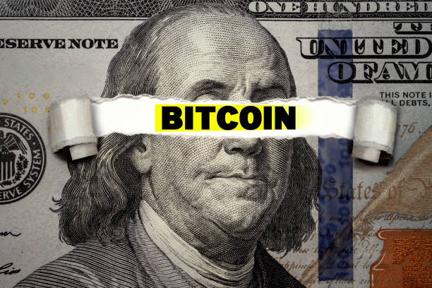 istock Torn bills revealing BITCOIN words. Ideas for blockchain technology and traditional currency 1324217754