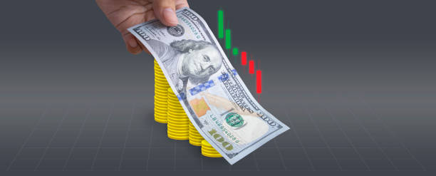 Successful money financial investment concept,100 Dollar bill lay on top of coins stock photo