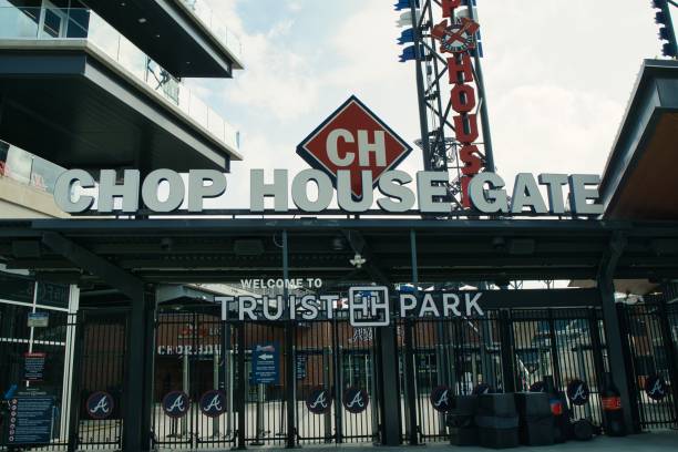 Entrance to Truist stadium in Atlanta, GA Atlanta, GA, USA: June 12,2021-An entrance to Truist Stadium in  Atlanta, Georgia. The stadium is a ballpark and the home field of Major League Baseball team of Atlanta Braves and is located in a multi use complex The Battery with many shops and restaurants. american league baseball stock pictures, royalty-free photos & images