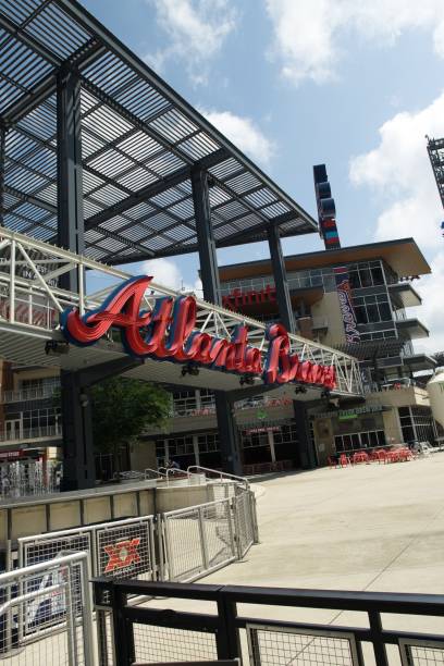 Entrance to Truist stadium in Atlanta, GA Atlanta, GA, USA: June 12,2021-An entrance to Truist Stadium in  Atlanta, Georgia. The stadium is a ballpark and the home field of Major League Baseball team of Atlanta Braves and is located in a multi use complex The Battery with many shops and restaurants. american league baseball stock pictures, royalty-free photos & images