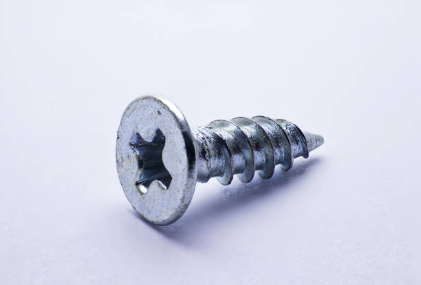 Small iron screws. Various fasteners. Close-up on a white background.