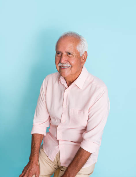 istock Cute senior man sitting and smiling away 1324220776