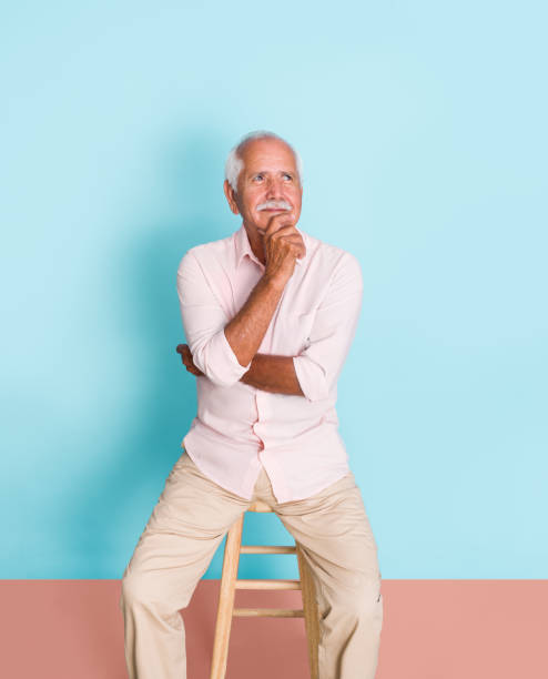 istock Senior man sitting and thinking with smile 1324220788