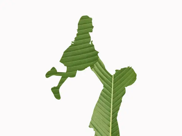 Green Eco-Friendly father's day concept. 3D Father and daughter shape isolated on a green leaf. Environment Day, Earth Day, Nature Day