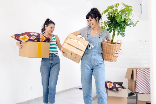 istock Happy twins moving in and bringing their staff 1324223324