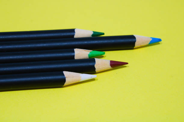 istock Coloured pencils on yellow background 1324223588