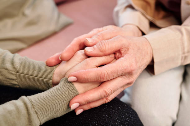 istock Hands of mature and young women during support 1324223863