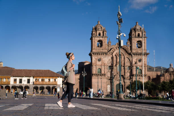 istock Tourist walking around Cusco in front of the Cathedral 1324227699