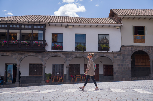 Happy Woman walking around the city of Cusco in Peru - traveling destinations concepts