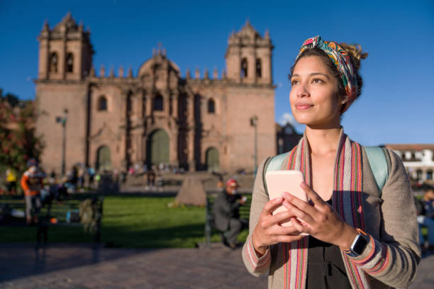 turismo turístico alrededor de cusco mientras envía mensajes de texto en su teléfono celular - provincia de cuzco fotografías e imágenes de stock