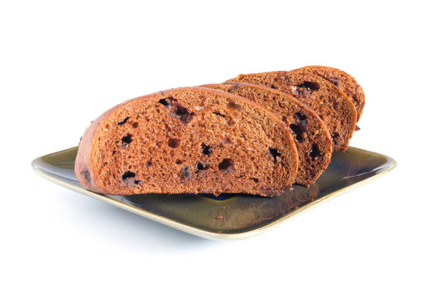 Slices of brown bread with sweet chocolate on white.