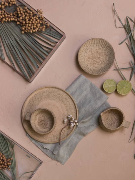 istock Green leaves and lime halves on a beige background 1324228895