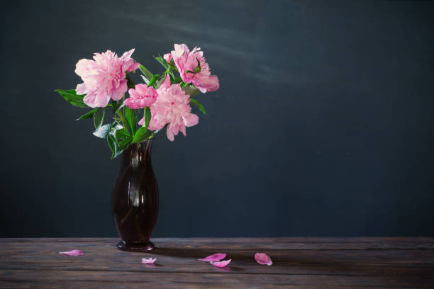 istock pink peony in  vase  on background dark wall 1324229280