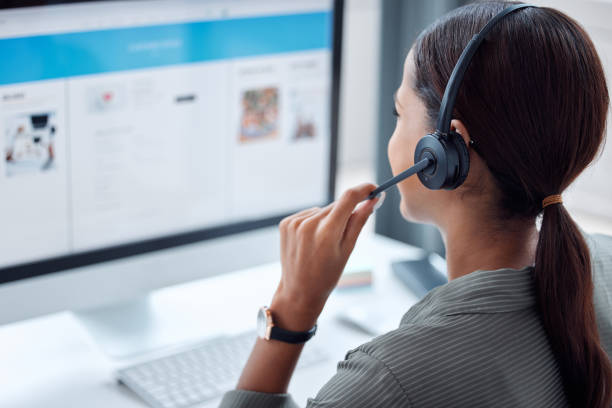 Shot of a businesswoman working in a call centre Your information is loaded on our system call centre stock pictures, royalty-free photos & images