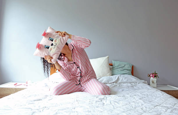 istock young beautiful woman waking up in her bed 1324229655