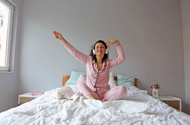 istock young beautiful woman waking up in her bed 1324229662