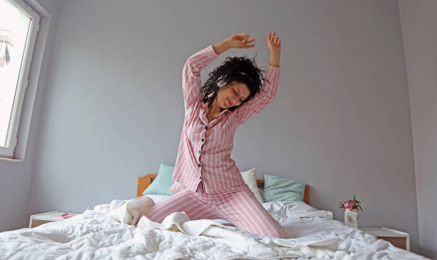 istock young beautiful woman waking up in her bed 1324229667