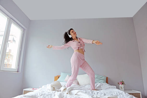 istock young beautiful woman waking up in her bed 1324230556