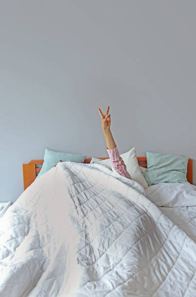 istock young beautiful woman waking up in her bed 1324230727