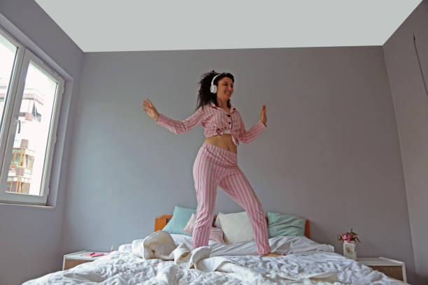 istock young beautiful woman waking up in her bed 1324230778
