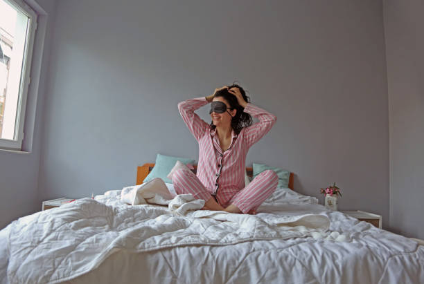 istock young beautiful woman waking up in her bed 1324230972