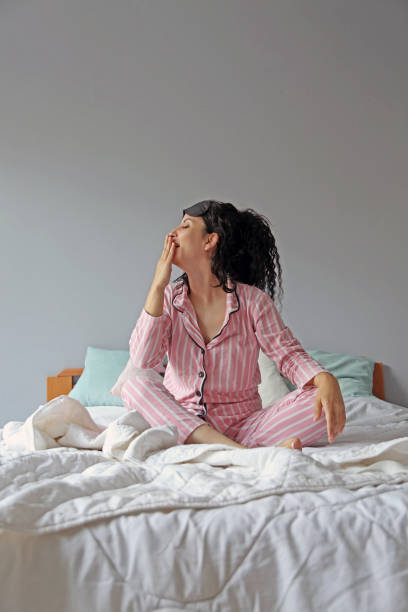 istock young beautiful woman waking up in her bed 1324231690
