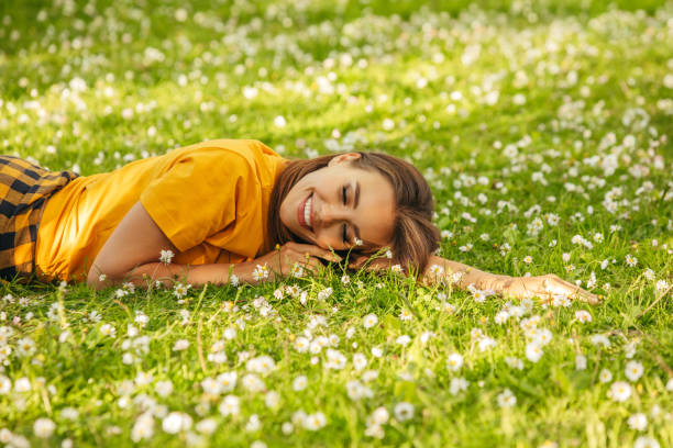 istock Beautiful woman lying on the grass 1324233188