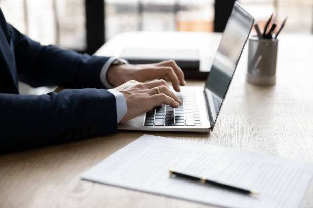istock Hands of businessman using app laptop at workplace 1324235318
