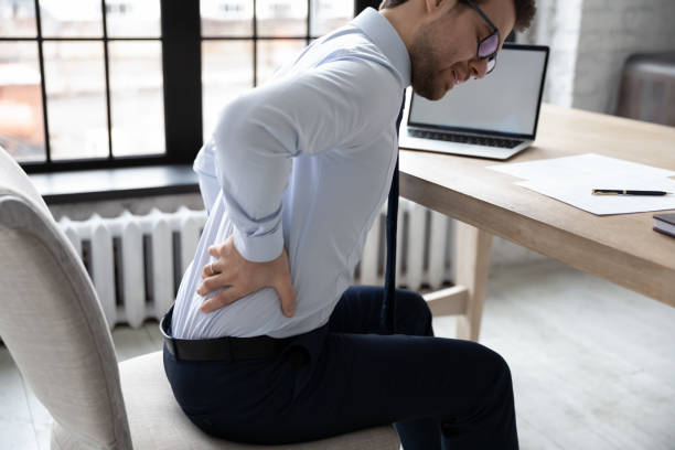 istock Upset young office employee suffering from chronic backache 1324235370