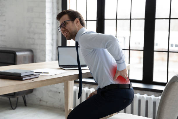 istock Upset office manager touching painful back and standing up 1324235377
