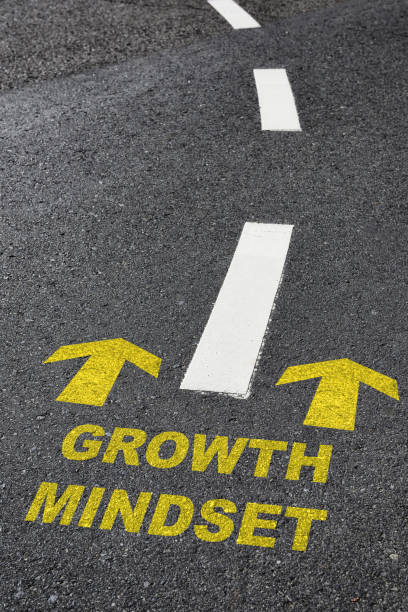 istock Growth mindset with yellow arrow marking on road surface with white marking line 1324236017